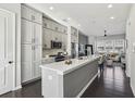 Modern kitchen with island, stainless steel appliances, and dark hardwood floors at 6442 Canopy Dr, Sandy Springs, GA 30328