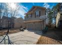 Two-story house with a two-car garage and a basketball hoop in the yard at 2777 Lakeview Walk, Decatur, GA 30035