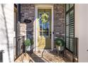 Inviting front entrance with a yellow door and brick accents at 364 Concord St, Alpharetta, GA 30009