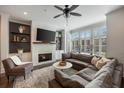 Spacious living room with a white brick fireplace and large windows at 364 Concord St, Alpharetta, GA 30009