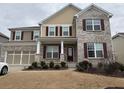 Two story house with brick and siding, three car garage, and landscaping at 522 Spring View Dr, Woodstock, GA 30188