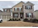 Inviting home with a covered porch, red shutters, and an attached two-car garage at 522 Spring View Dr, Woodstock, GA 30188