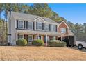 Two-story house with gray and brick exterior, landscaping, and a driveway at 1016 Madeline Ct, Loganville, GA 30052