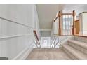 Elegant staircase with hardwood floors and white railings at 2790 Laurel Valley Trail, Buford, GA 30519