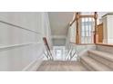 Indoor stairway with wood railing and carpet runner at 2790 Laurel Valley Trl, Buford, GA 30519