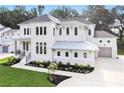 Two story white brick home with gray metal roof and landscaping at 600 Autumn Ln, Marietta, GA 30068