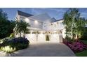 Three-car garage with white doors and landscaping at 600 Autumn Ln, Marietta, GA 30068