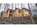 Hillside home with stucco exterior, multiple balconies and large windows at 1605 Brandon Hall Dr, Atlanta, GA 30350