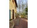 Welcoming front entrance with arched entryway, brick walkway and terracotta pots at 1605 Brandon Hall Dr, Atlanta, GA 30350