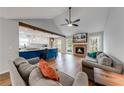 Inviting living room featuring a cozy fireplace, hardwood floors, and an open-concept kitchen at 2205 Castle Royale Dr, Lawrenceville, GA 30043