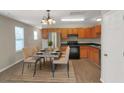 Modern kitchen with wood cabinets, stainless steel appliances, and dining area at 1177 Arlington Ave, Atlanta, GA 30310