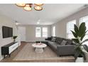 Spacious living room featuring a gray sectional sofa and a large TV at 1177 Arlington Ave, Atlanta, GA 30310