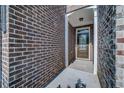 Dark brown front door entry with brick exterior at 1216 Foxcroft Ln, Cumming, GA 30041