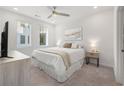 Bright bedroom features plush carpet, a ceiling fan, and a comfortable queen-sized bed at 396 Pratt Se Dr # 1932, Atlanta, GA 30315