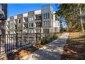 Apartment building with balconies and walking path, surrounded by trees at 396 Pratt Se Dr # 1932, Atlanta, GA 30315