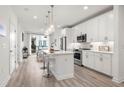 Modern kitchen features white cabinets, quartz countertops, stainless steel appliances, and a center island with bar seating at 396 Pratt Se Dr # 1932, Atlanta, GA 30315