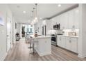 Modern kitchen featuring white cabinets, stainless steel appliances, and an island with bar seating at 396 Pratt Se Dr # 1932, Atlanta, GA 30315