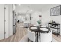 Open-concept kitchen and dining area featuring stainless steel appliances and modern decor at 396 Pratt Se Dr # 1932, Atlanta, GA 30315
