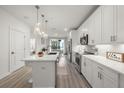 Bright kitchen featuring quartz countertops, stainless steel appliances, modern lighting, and a central island at 396 Pratt Se Dr # 1932, Atlanta, GA 30315