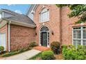 Brick front entry with a black door and arched window at 232 Spalding Drive Dr, Atlanta, GA 30328