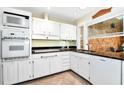 Kitchen features white cabinets, granite counters, and tile floors at 3880 Admiral Dr, Atlanta, GA 30341