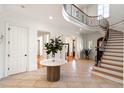 Bright and spacious entryway, featuring a curved staircase and tile floors at 4231 Whitestone Pl, Atlanta, GA 30327