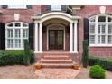 Elegant front entrance with brick steps, columns, and double doors at 2214 Taylor Grady Ter, Duluth, GA 30097