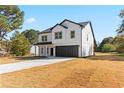 Two-story house with white siding, dark trim, and a two-car garage at 351 Willowwind Dr, Loganville, GA 30052