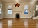 Spacious living room featuring hardwood floors, a fireplace, and large windows at 249 Josephine Ne St, Atlanta, GA 30307