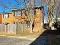 Brick townhouse with wooden fence and landscaping at 6520 Roswell Rd # 3, Atlanta, GA 30328