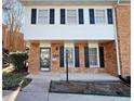 Two-story brick townhouse with black shutters at 6520 Roswell Rd # 3, Atlanta, GA 30328