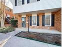 Two-story brick townhouse with black shutters at 6520 Roswell Rd # 3, Atlanta, GA 30328