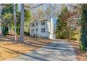 Two-story house with driveway, surrounded by tall trees at 1741 Charrington Way, Powder Springs, GA 30127