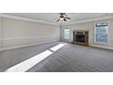 Bright and airy living room featuring a fireplace and neutral decor at 8372 Members Dr, Jonesboro, GA 30236