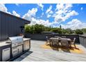 Amazing rooftop deck with city views, outdoor kitchen, and dining furniture at 617 East Ave, Atlanta, GA 30312