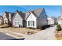 Two-story home with stone and white siding, landscaping, and a paved driveway at 191 Foxtail Rd, Woodstock, GA 30188