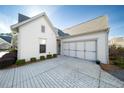 Two-car garage with paver driveway and landscaping at 191 Foxtail Rd, Woodstock, GA 30188