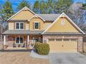 Charming two-story home with brick and tan siding, two-car garage, and covered porch at 1227 Clear Stream Rdg, Auburn, GA 30011