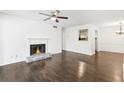 Living room with dark hardwood floors, fireplace, and view to kitchen at 2408 Country Park Se Dr, Smyrna, GA 30080