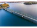 Aerial view of bridge over lake with shoreline trees at 6939 Melody Dr, Buford, GA 30518