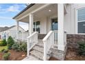 Charming front porch with stone detailing and white columns at 6939 Melody Dr, Buford, GA 30518