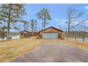 Front view of house with attached garage and lake view at 350 Polk Rd, Covington, GA 30014