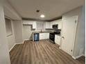 Modern kitchen with white cabinets, granite counters, and stainless steel appliances at 5449 Martins Crossing Rd, Stone Mountain, GA 30088