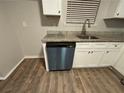 Close-up view of kitchen sink and dishwasher; granite countertop at 5449 Martins Crossing Rd, Stone Mountain, GA 30088