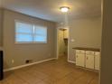 Simple dining area with tile floor and access to kitchen and laundry at 10650 Panhandle Rd, Hampton, GA 30228