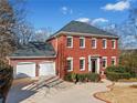 Two-story brick home with attached two-car garage at 6103 Governors Walk Dr, Canton, GA 30115