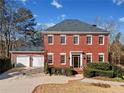 Red brick home with a large front yard at 6103 Governors Walk Dr, Canton, GA 30115