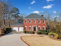 Two-story brick home with a two-car garage at 6103 Governors Walk Dr, Canton, GA 30115