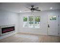 Light-filled living room featuring a modern electric fireplace and hardwood floors at 1807 W Austin Rd, Decatur, GA 30032