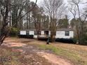 White mobile home with deck, trees in background at 3520 Haynes Ridge Rd, Loganville, GA 30052